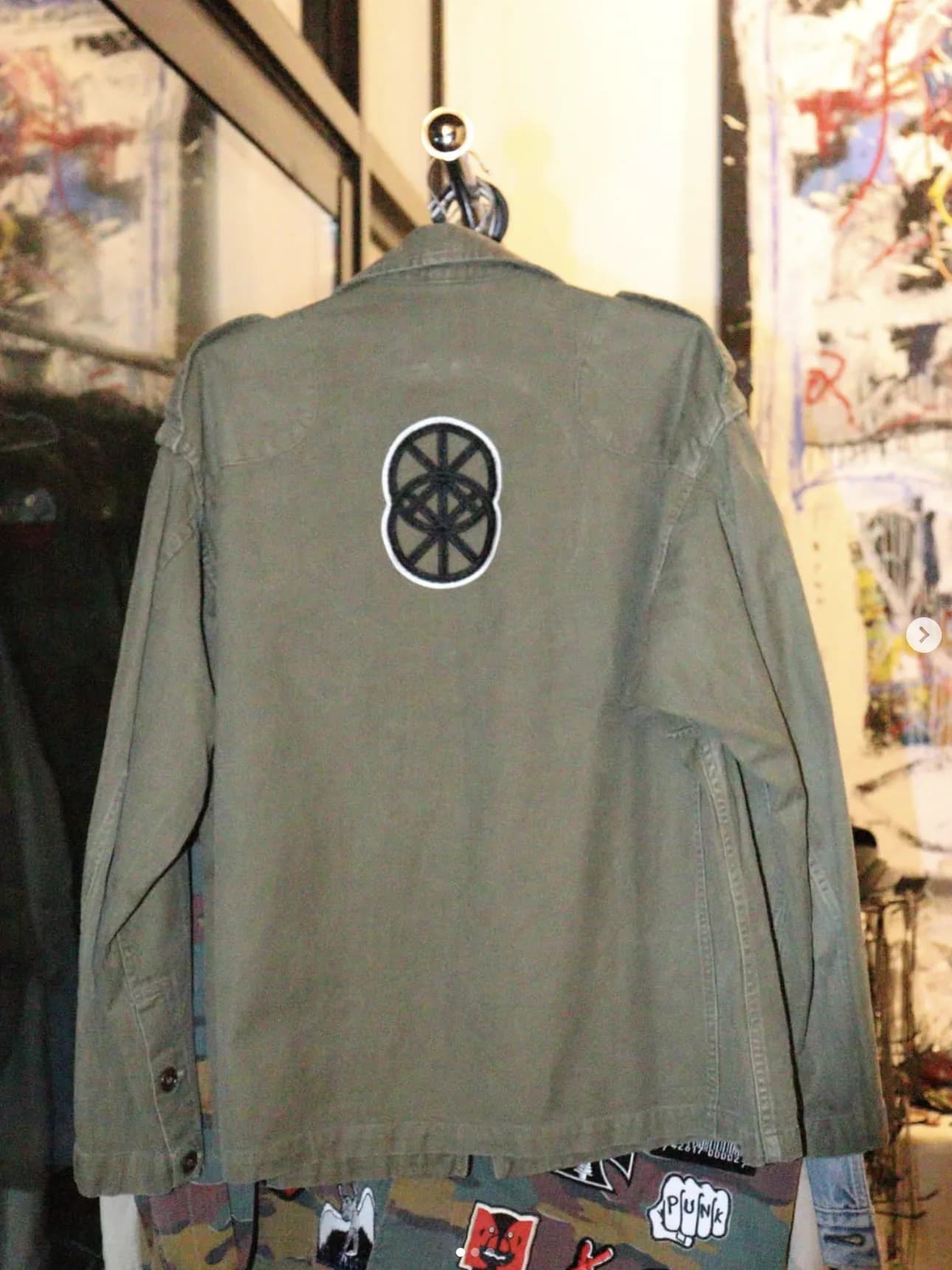 Rack of custom military jackets with patches at the showroom
